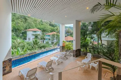 a view of a pool from the balcony of a house at C195 Romantic 1BR Ocean Views Cozy & Bright in Kata Beach