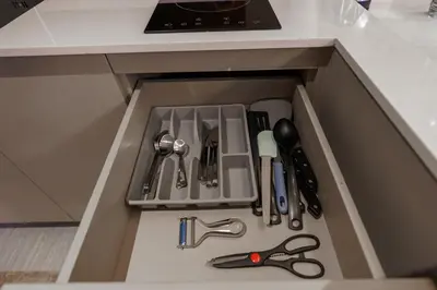 a drawer in a kitchen withrenches and utensils at New 1 Bdr Bellevue Lagoon Bang-Tao Beach in Laguna Phuket