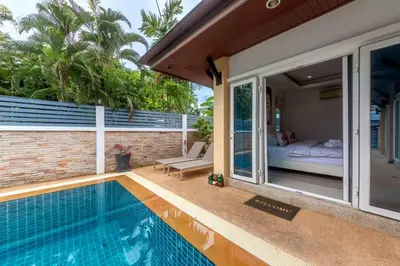 a house with a swimming pool next to a bedroom at 3 Bedroom Pool Villa 5kms from Patong in Kathu