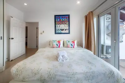 a bedroom with a large bed with two teddy bears on it at 3 Bedroom Pool Villa 5kms from Patong in Kathu