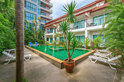 a swimming pool in front of a building at C199 Condo 1BR Walk to Lake, Beach, Bars & Market in Rawai Beach