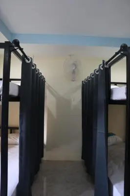 a room with two bunk beds and a ceiling at Cocoloco hostel in Ban Khlong Haeng