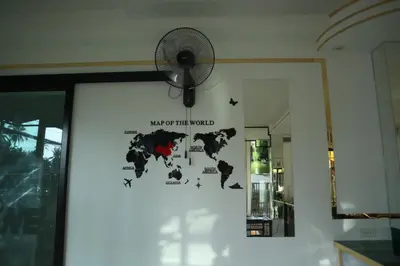 a fan hanging on a wall next to a door at Cocoloco hostel in Ban Khlong Haeng
