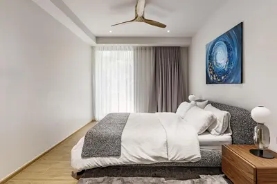 a white bedroom with a bed and a window at Laguna Beachside by ShowProperty in Bang Tao Beach