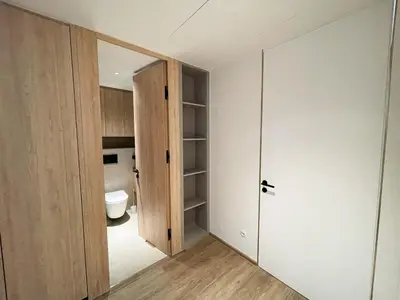 an empty bathroom with a toilet and a door at Layan Green Residence by ShowProperty in Layan Beach