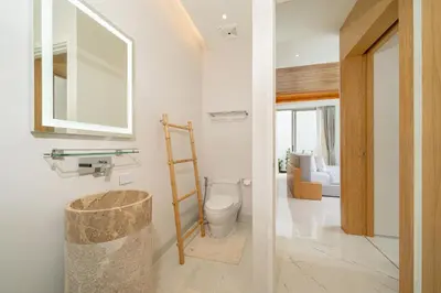 a bathroom with a toilet and a mirror at LuxPride 4BR Spacious Pool Villa for Group and Families in Ban Pak Lak
