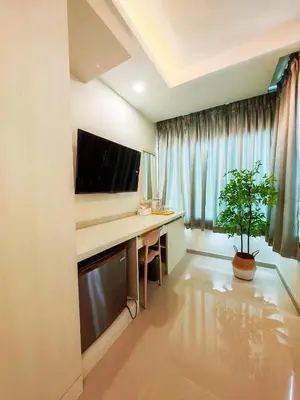 a room with a computer desk with a potted plant at The Sleepy Place in Patong Beach
