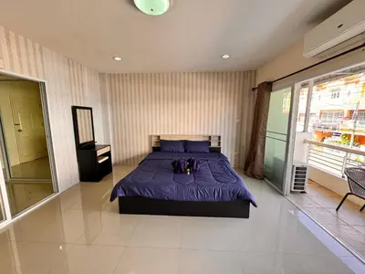 a bedroom with a bed with a purple bedspread at Tropikathu Guest House in Kathu