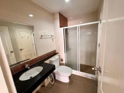 a bathroom with a toilet and a sink and a shower at Tropikathu Guest House in Kathu