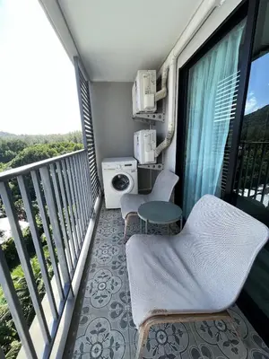 a balcony with two chairs and a table at G16 Title Naiyang 36м2Ватсап669З5В2I976 in Nai Yang Beach