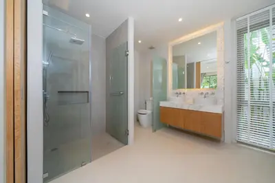 a bathroom with a shower and a sink and a toilet at 3 Bedroom Villa with Private pool in Laguna Phuket