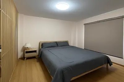 a bedroom with a large bed and a window at Vista Old Town Phuket in Phuket Town