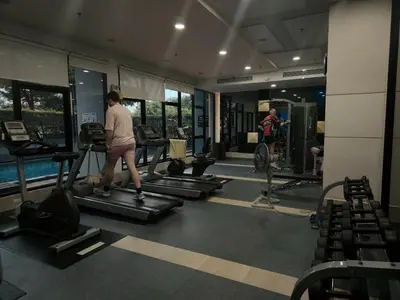 a man walking on a treadmill in a gym at Vista Old Town Phuket in Phuket Town