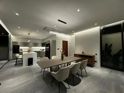 a dining room and kitchen with a table and chairs at The Nature Villa Phuket in Rawai Beach