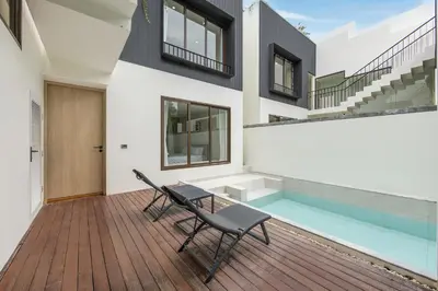 a house with a swimming pool and a table and chairs at Qabalah 2BR Villa Pool Rooftop Near Bangtao by TropicLook in Bang Tao Beach
