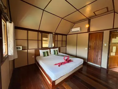 a bedroom with a bed with a pink animal on it at Phi Phi Ingphu Viewpoint Hotel in Phi Phi Don