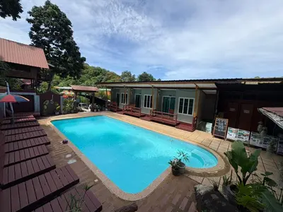 a large swimming pool in front of a house at Phi Phi Ingphu Viewpoint Hotel in Phi Phi Don