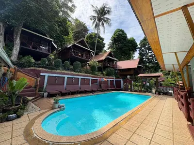 a swimming pool in front of a house at Phi Phi Ingphu Viewpoint Hotel in Phi Phi Don