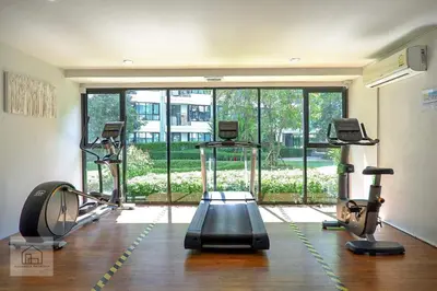 a gym with three treadmills and a large window at Centrio 2 bed rooms in Phuket Town