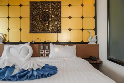 a bedroom with a bed with a bride and groom on it at C202 Sun and Fun Kids Club 1BR 500m to Beach in Kata Beach