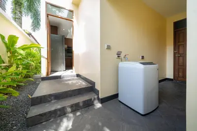 a hallway with a washer and dryer in a house at Ocean Palms Private Pool Villas in Ban Thalat Choeng Thale