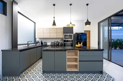 a kitchen with a large island with black counter tops at New 2-Storey Villa Sunset Garden 8 with 4BR & Eco-Pool, near Naiharn in Rawai Beach