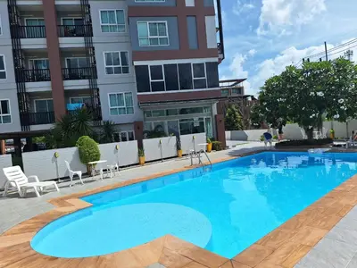 a large blue swimming pool in front of a building at The Sea Condo Ao Nang Apartment Relax with Sea View in Ban Khlong Haeng