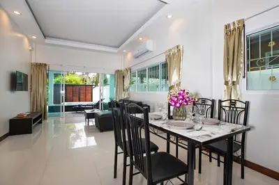a dining room with a table and chairs at Family 2BR Villa Lancelot 3 with Jacuzzi Pool, just 10 min drive NaiHarn and Rawai in Rawai Beach