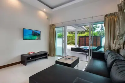 a living room with a couch and a table at Family 2BR Villa Lancelot 3 with Jacuzzi Pool, just 10 min drive NaiHarn and Rawai in Rawai Beach