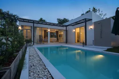 a swimming pool in the backyard of a house at Your Tropical Island Home - New & Modern 2BR Pool Villa Seamate in Chalong