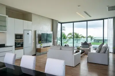 a living room with white furniture and large windows at Luxury Beachfront Sea-View Retreat & Pool in Natai in Ban Na Tai