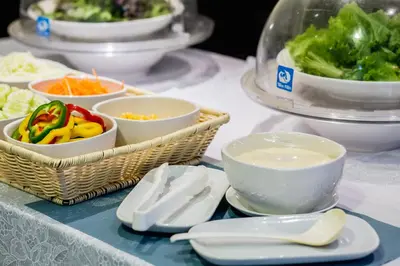 a table with bowls and plates of vegetables on it at Phi Phi Cliff Beach Resort in Phi Phi Don