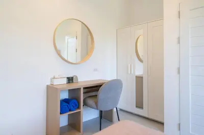 a desk and a chair in a room with a mirror at Villa Chandlers - Goldena Twin in Kamala Beach