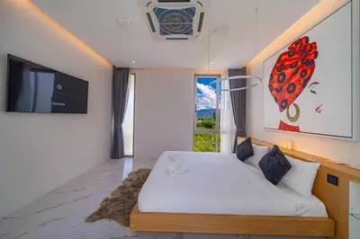 a bedroom with a bed and a large window at The Residence Tropical 3BR Villa with Private Pool in Ban Pak Lak