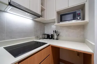 a kitchen with a sink and a microwave at Apartment at Laguna Beachside by Lofty in Bang Tao Beach