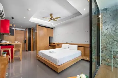 a bedroom with a bed and a ceiling fan at Relife 5 mins walk to the beach in Rawai Beach