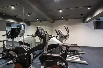 a gym with several cardio machines in a room at Ocean View 3BR Apartment with Rooftop Terrace, Sapphire Bay 8-19 Residence in Patong Beach
