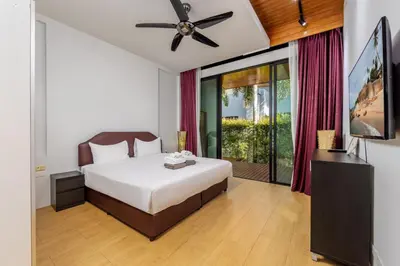 a bedroom with a bed and a ceiling fan at Villa Fam with Private Pool Near Nai Harn Beach in Rawai Beach