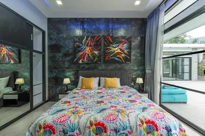 a bedroom with a bed and a painting on the wall at V204 Tropical Score 3BR with Pool, Tub & Snooker in Rawai Beach