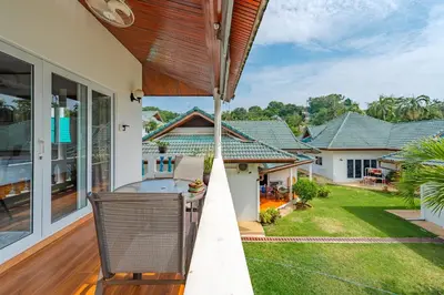 an outdoor deck with a view of a house at V205 Island Hideaway Near Promthep Sunset in Nai Harn Beach