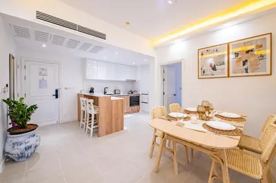 a dining room and kitchen with a table and chairs at JSD Prime Property-Cherngtalay in Laguna Phuket