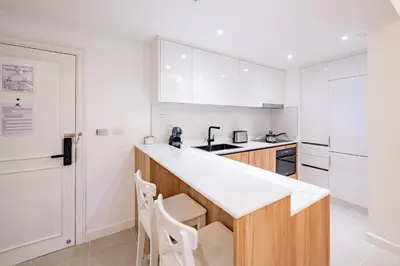 a kitchen with white cabinets and a white counter top at JSD Prime Property-Cherngtalay in Laguna Phuket