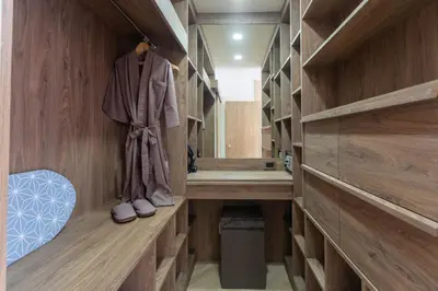 a walk in closet with wooden walls and wooden floors at Calipso Garden 108 in Rawai Beach