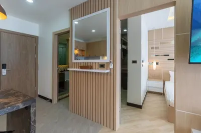 a room with a hallway with a mirror and a kitchen at Calipso Garden 108 in Rawai Beach