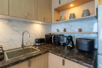 a kitchen with a sink and a counter top at Calipso Garden 304 in Rawai Beach
