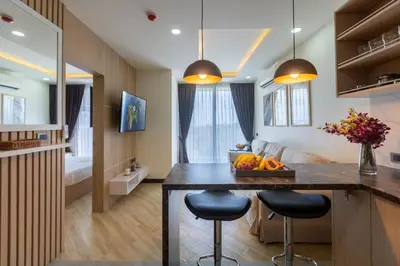 a kitchen with a counter and two stools in a room at Calipso Garden 304 in Rawai Beach