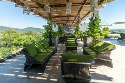 a row of green chairs on a patio at Calipso Garden 312 in Rawai Beach