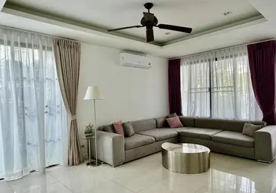 a living room with a couch and a ceiling fan at Spacious 3 bedroom townhouse in Laguna in Laguna Phuket