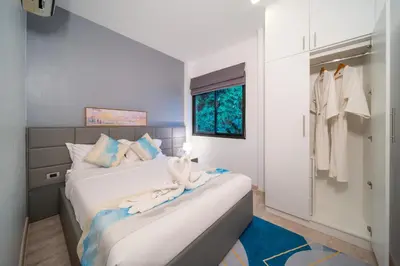 a bedroom with two beds and a closet at \u4e5d\u96c5\u96c6 The Nine Refined Retreats in Rawai Beach