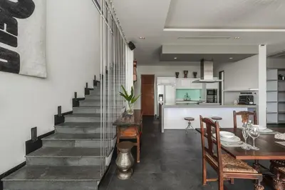 a kitchen and dining room with a staircase in a house at V203 Seahorse Villa Stunning 4BR Oceanview Retreat in Bang Tao Beach